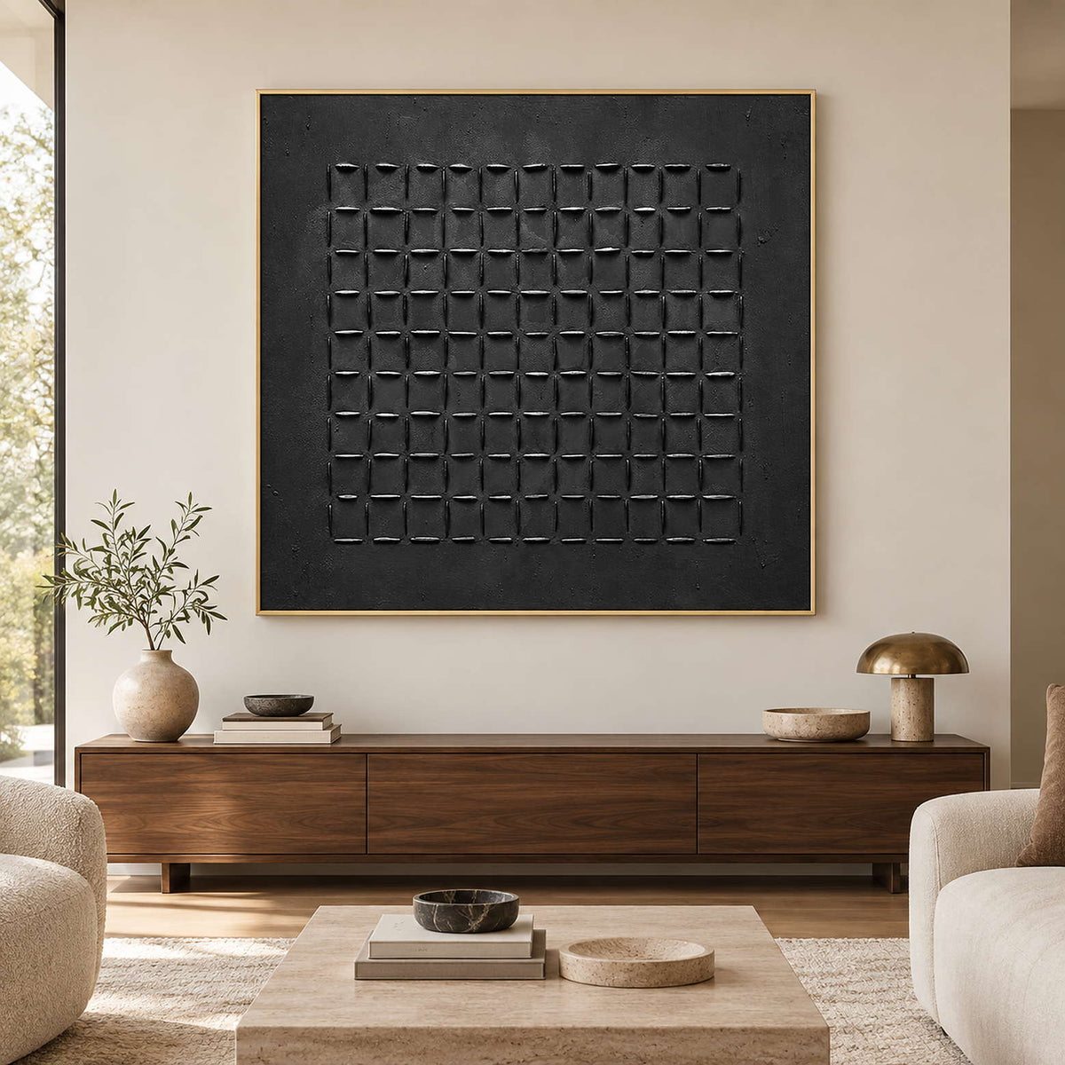 Black grid artwork in a gold-toned frame above a long wood living room cabinet.