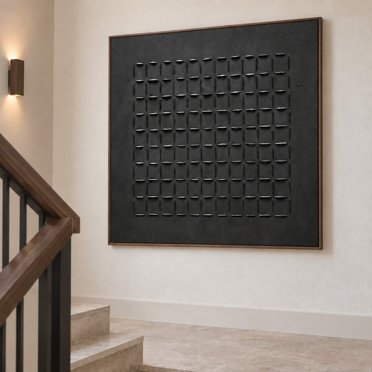 Angled view of the black grid artwork on a pale stairwell wall.