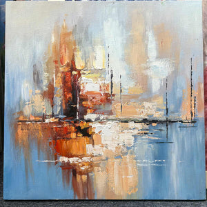 Photographed view of amber and rust blocks crossing a dark horizontal line on pale blue, with the artwork edge and surrounding background visible.