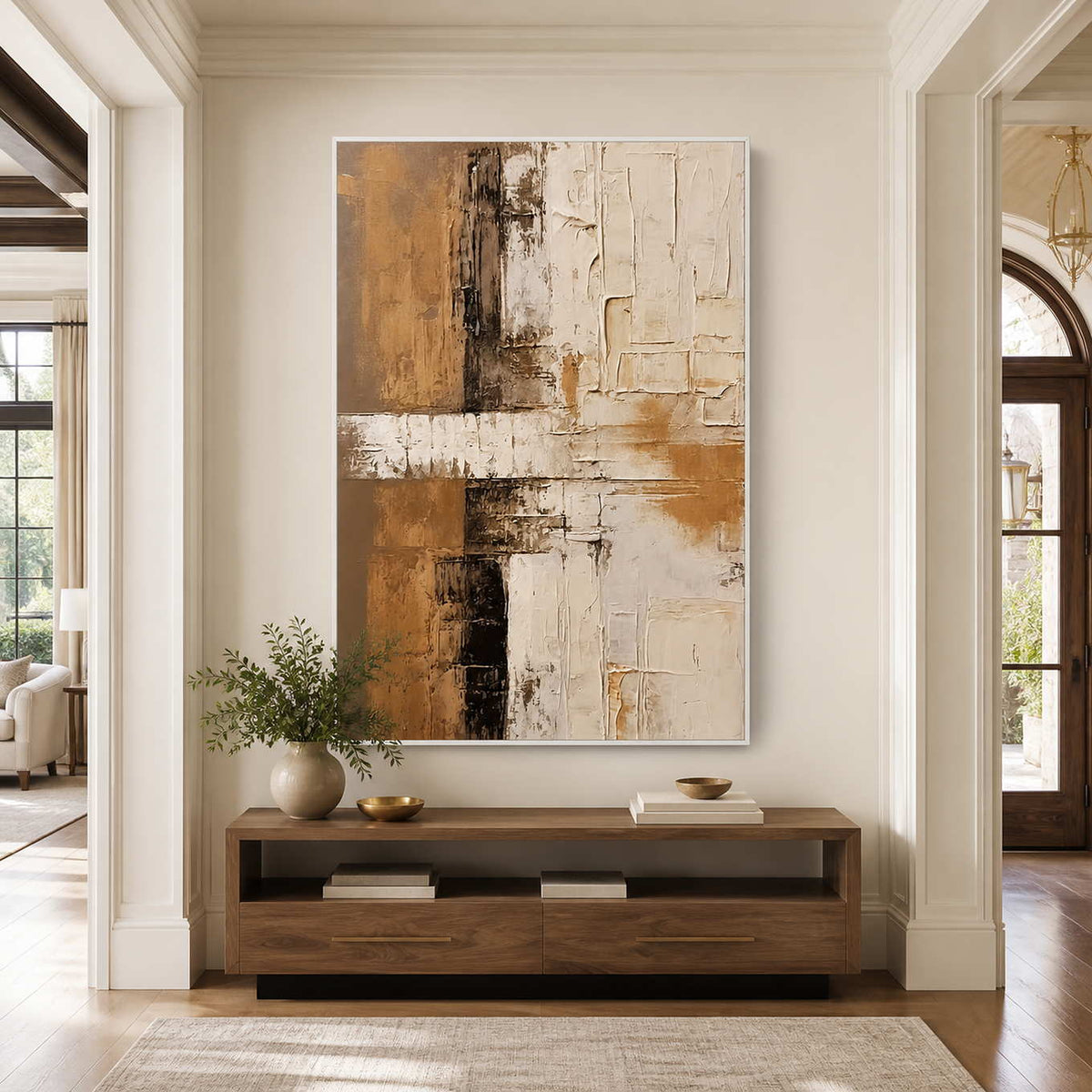 White-framed textured abstract wall art above a wooden console in a hallway.