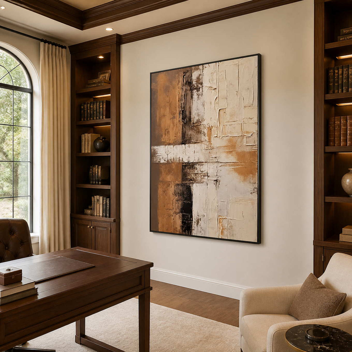 Black-framed abstract wall art between wooden bookcases in a warm study.