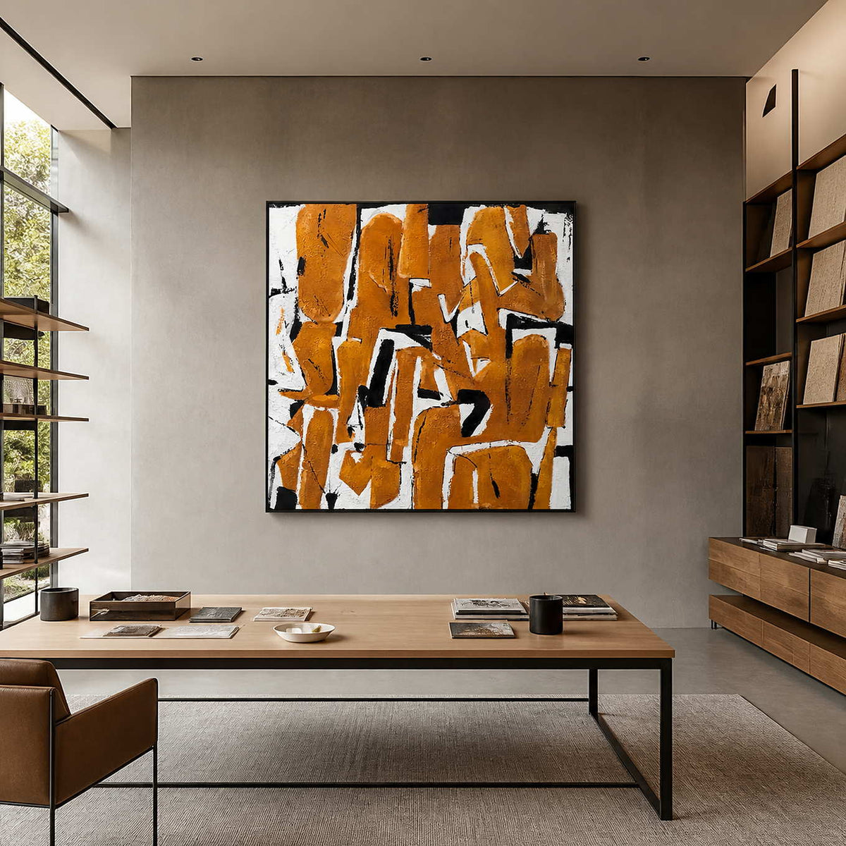 An Eager Embrace in a black frame behind a large worktable in a contemporary design studio.