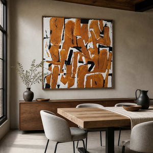 Wood-framed An Eager Embrace above a sideboard beside a light wood dining table and neutral chairs.