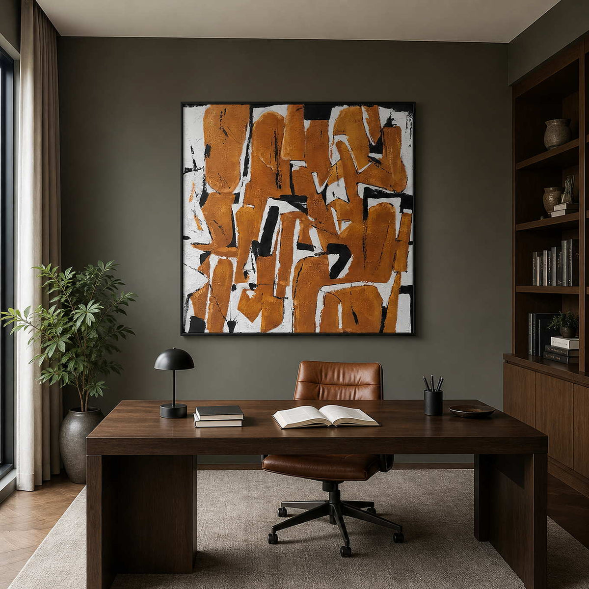 An Eager Embrace in a black frame above a wood desk and leather chair in a home study.