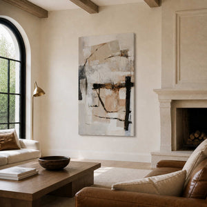 Frameless cream and beige abstract artwork beside a stone fireplace in a furnished living room.