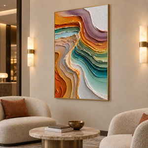 Warm and cool abstract curves above a round table between two cream lounge chairs.