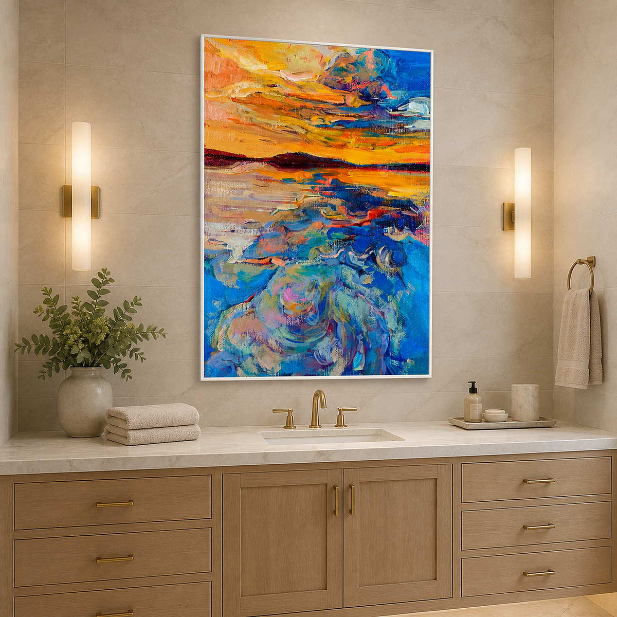 White framed vivid sunset painting above a bathroom vanity between warm wall lights.