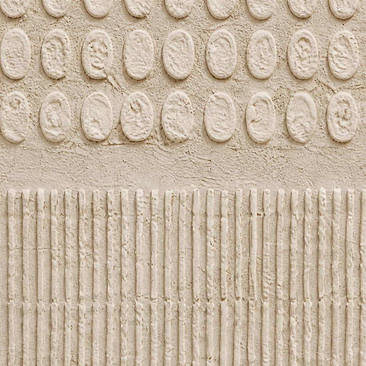 Close-up of hand-built ivory relief marks meeting finely combed texture.