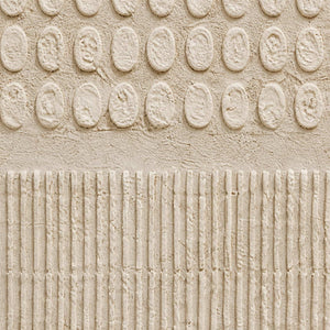 Close-up of hand-built ivory relief marks meeting finely combed texture.
