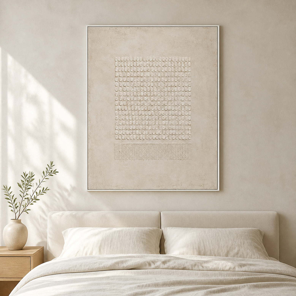 Ivory geometric relief artwork displayed in a soft white bedroom.