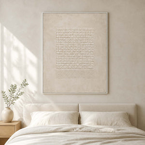 Ivory geometric relief artwork displayed in a soft white bedroom.