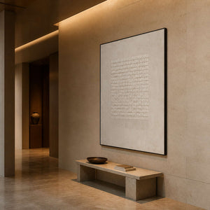 Minimalist textured art displayed in a warm stone hotel corridor.