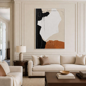 White-framed abstract wall art above a cream sofa in an elegant living room.