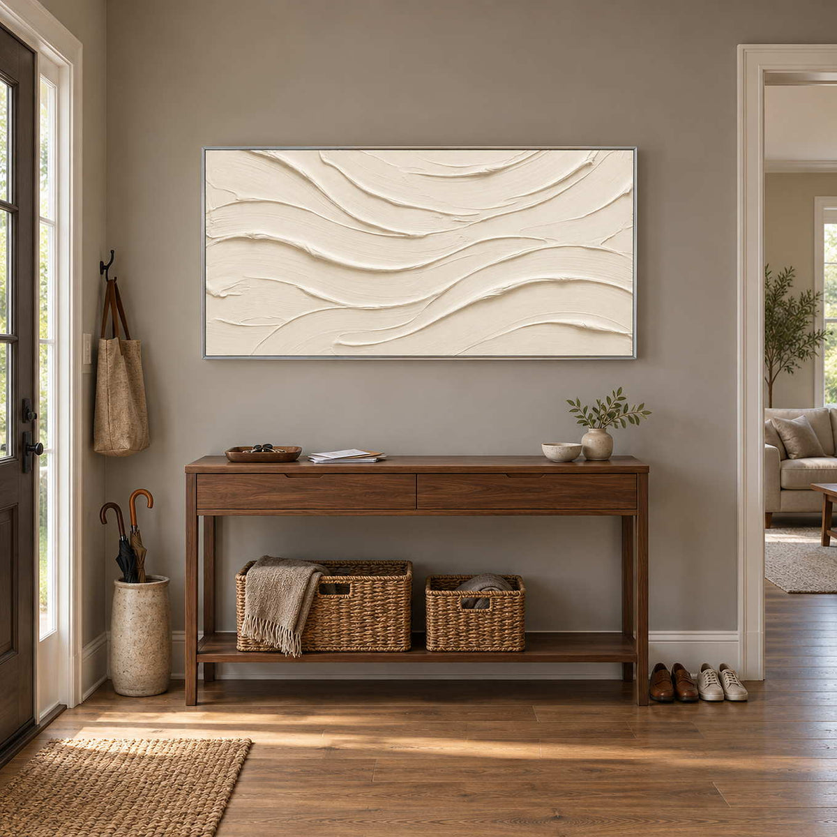 An Unhurried Flow in a silver frame above a wood entryway console with woven baskets beneath.