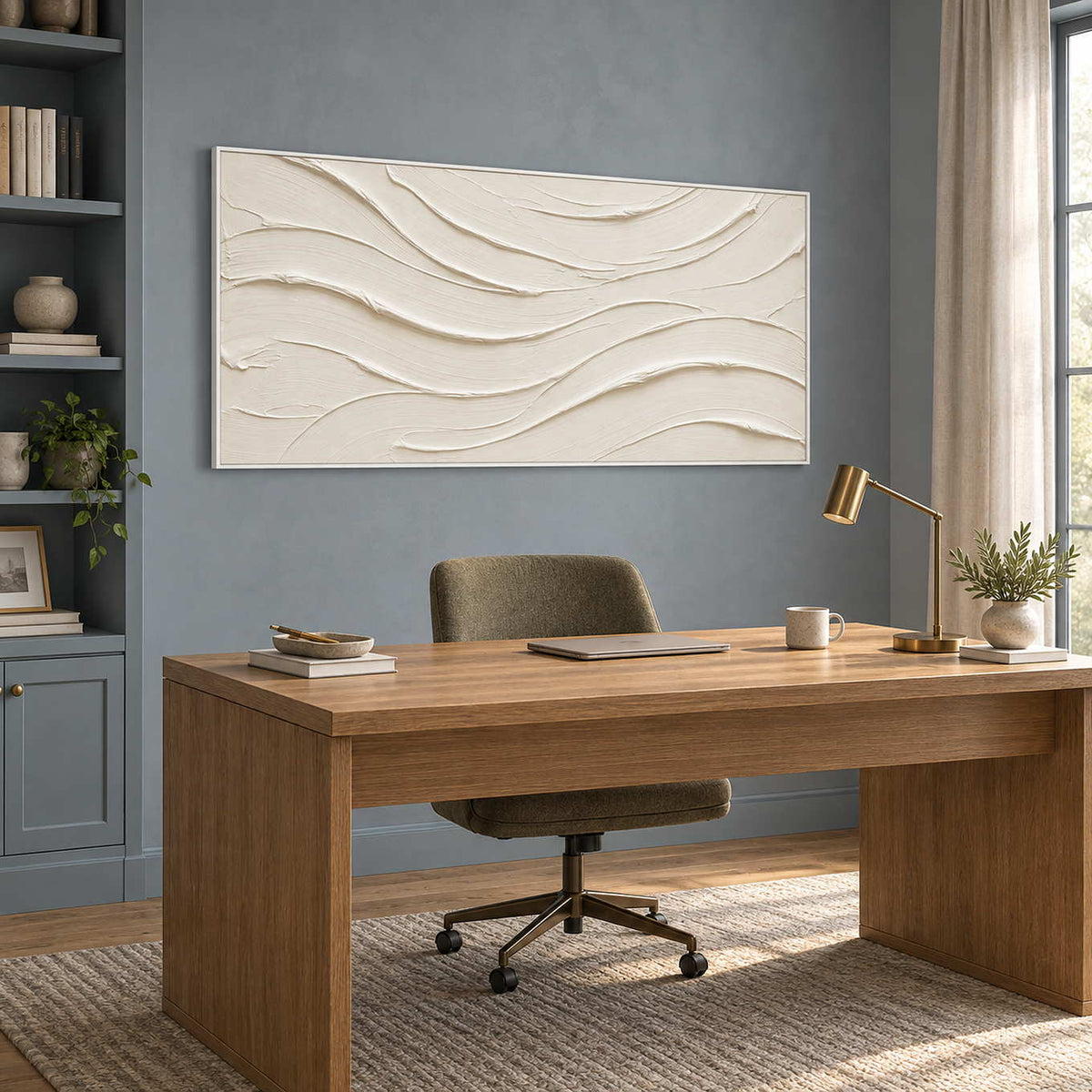 An Unhurried Flow in a white frame above a broad wood desk against a blue-gray home-office wall.