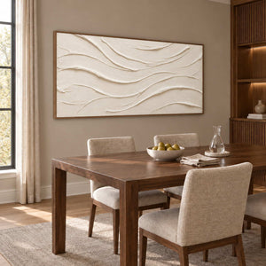 An Unhurried Flow in a brown wood frame above a rectangular wood dining table and upholstered neutral chairs.
