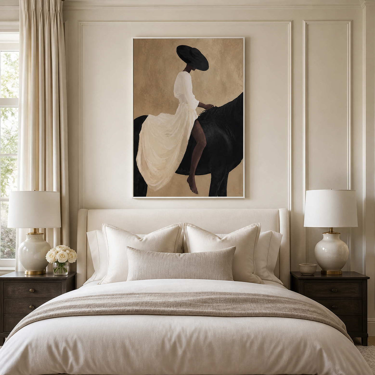 White framed rider and horse painting above a cream upholstered bed.
