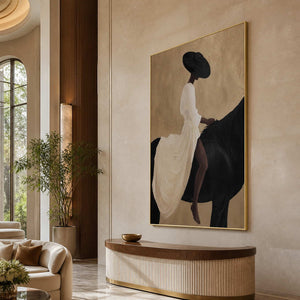 Gold framed equestrian wall art above a curved console in a hotel lobby.