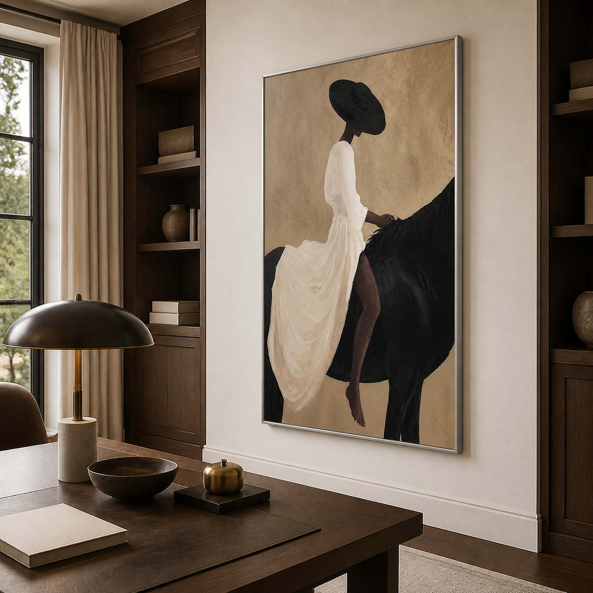 Silver framed equestrian wall art between bookshelves above a wooden desk.