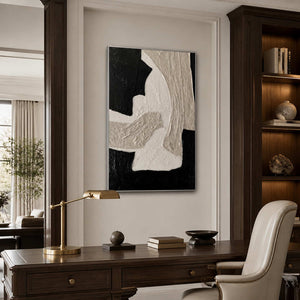 Silver framed textured abstract curves above a dark wooden office desk.