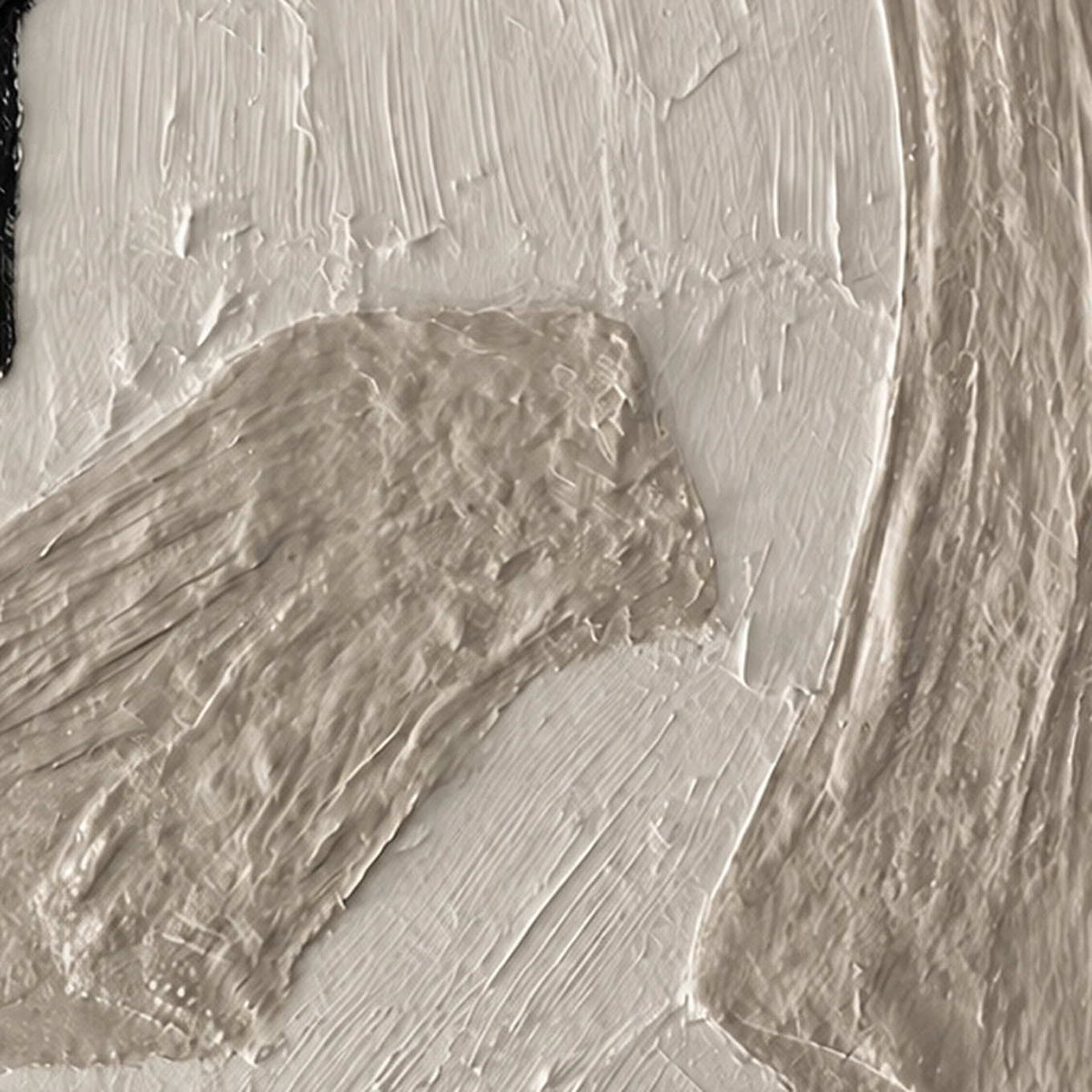 Close view of raised white and warm gray paint along overlapping curved forms.