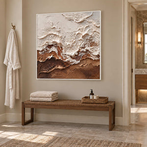At Ease in a white frame above a wood bench holding folded towels and a basket in a bathroom dry area.