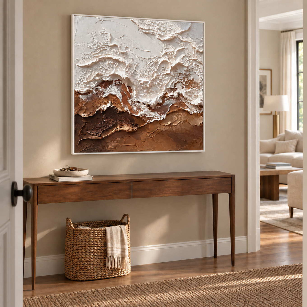 At Ease in a white frame above a narrow wood hallway console with a woven basket beneath.