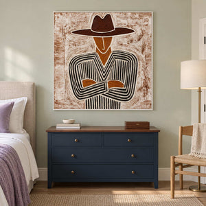 Striped figure artwork above a navy dresser on a pale green bedroom wall.