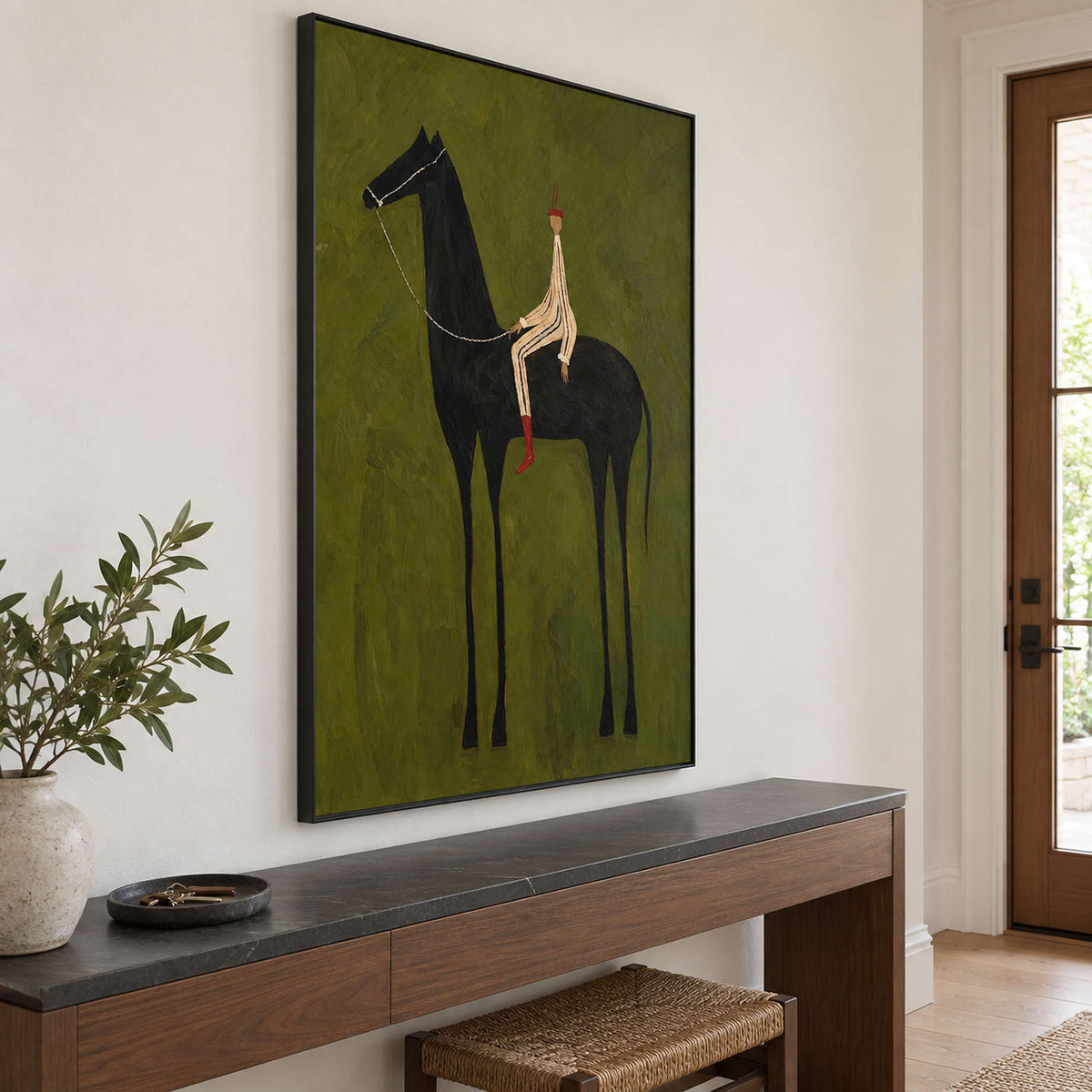 Angled view of horse-and-rider art above a dark-topped console.