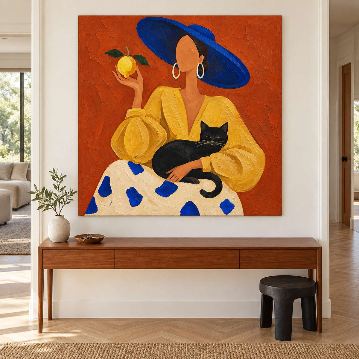 Blue-and-yellow figure painting above a narrow wooden console.