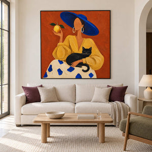 Cat-and-figure painting over a pale sofa with plum cushions.
