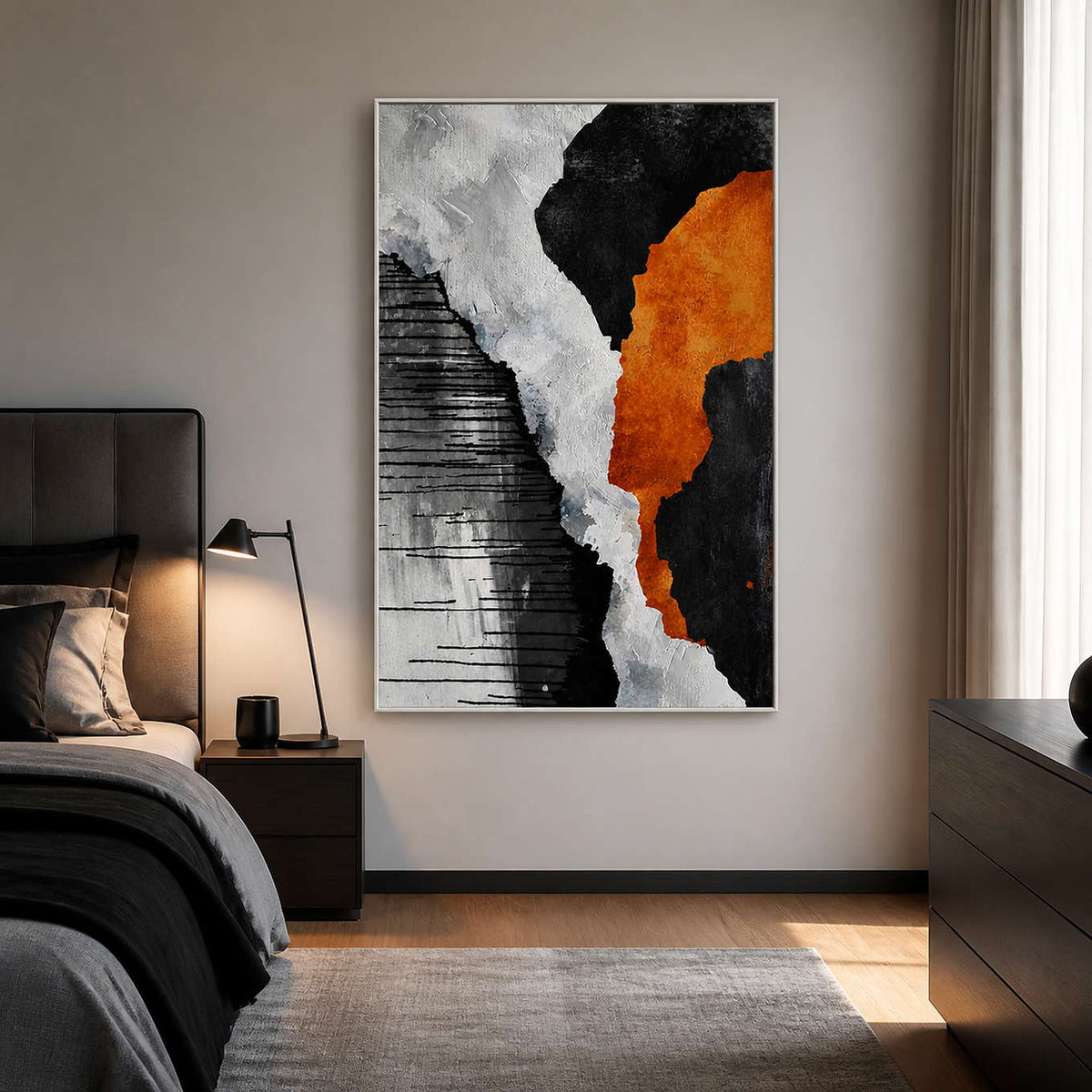 White framed orange and black abstract artwork on a bedroom side wall beside dark bedding.