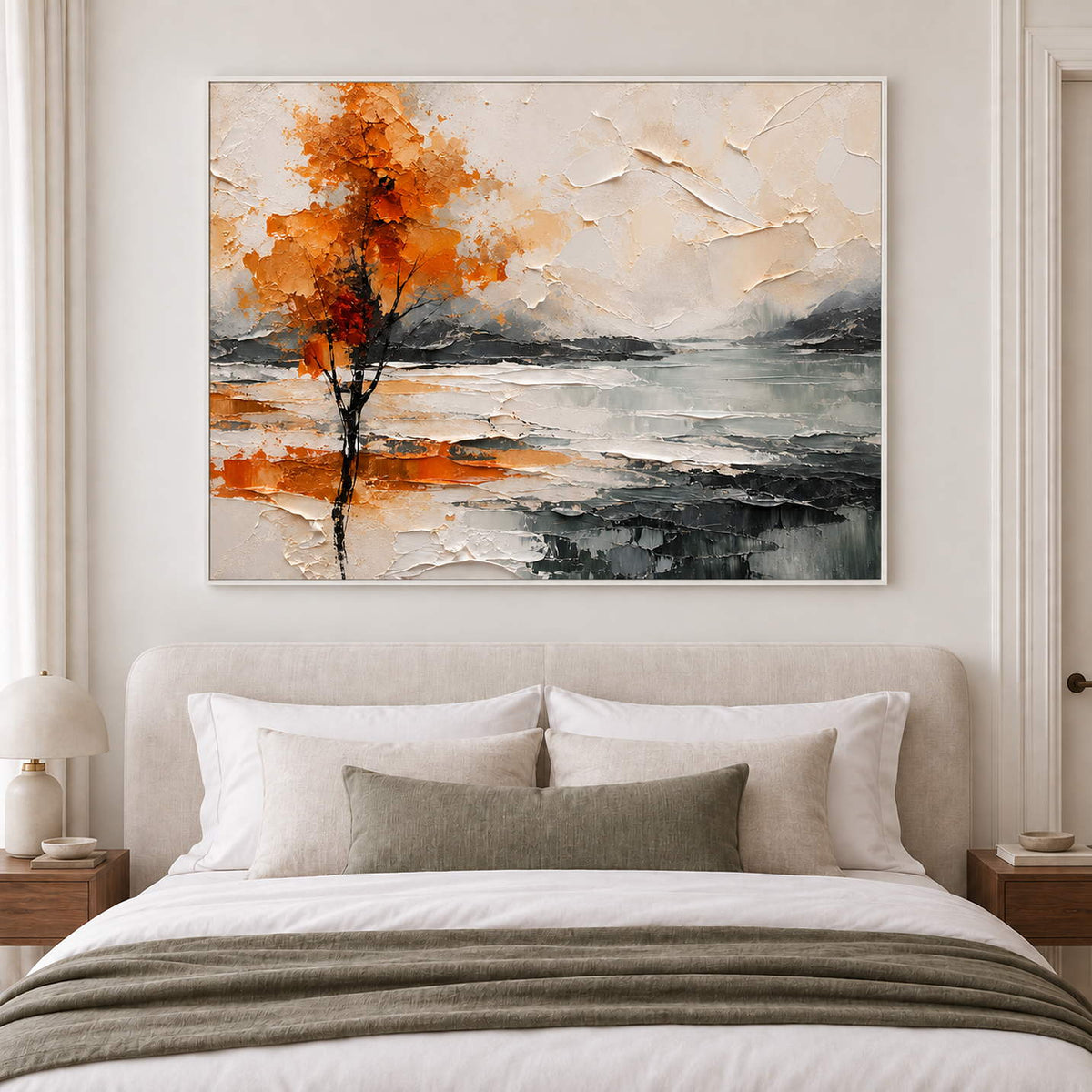 An orange autumn tree reflected beside a gray lake in a white frame, displayed above a bed.