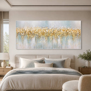 White framed panoramic autumn artwork above a cream bed with soft blue gray textiles.