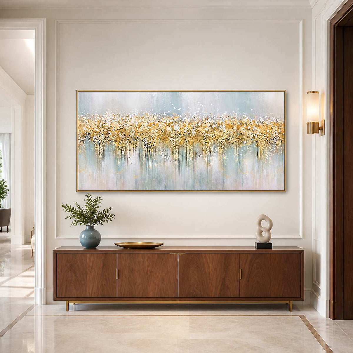 Gold framed panoramic abstract painting above a wood cabinet with blue and white ceramics.