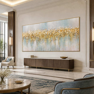 Gold framed pale blue abstract painting above a console in a spacious hotel lounge.