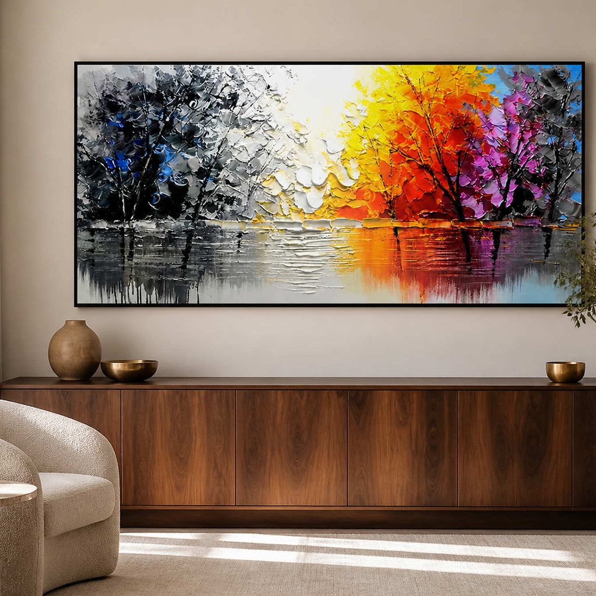 Black-framed lake painting with contrasting autumn foliage above a walnut study cabinet.