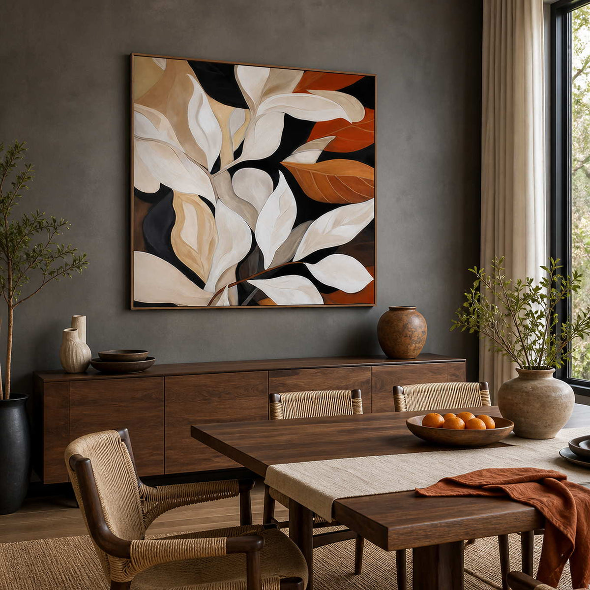 Wood framed autumn leaf painting above a dining sideboard beside a wooden table.