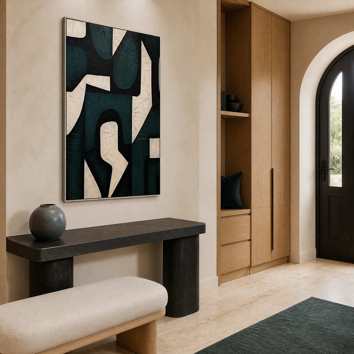 Silver framed interlocking shapes above a stone entry console beside an arched door.