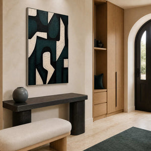 Silver framed interlocking shapes above a stone entry console beside an arched door.