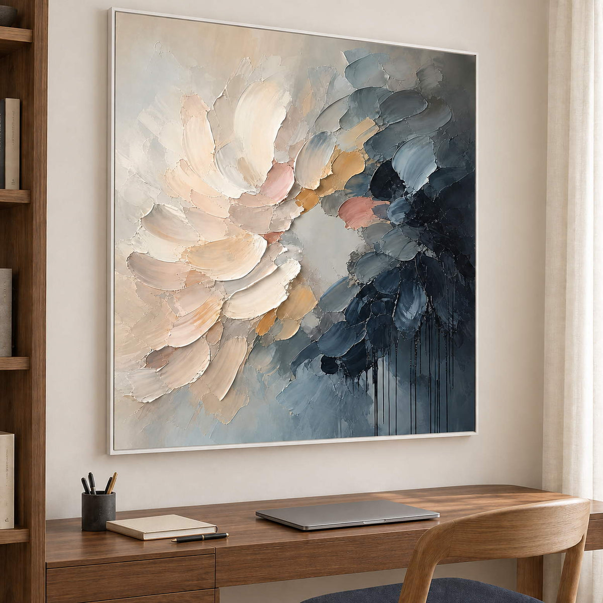Layered cream and blush petals fading into deep blue in a white frame, displayed in a home office.