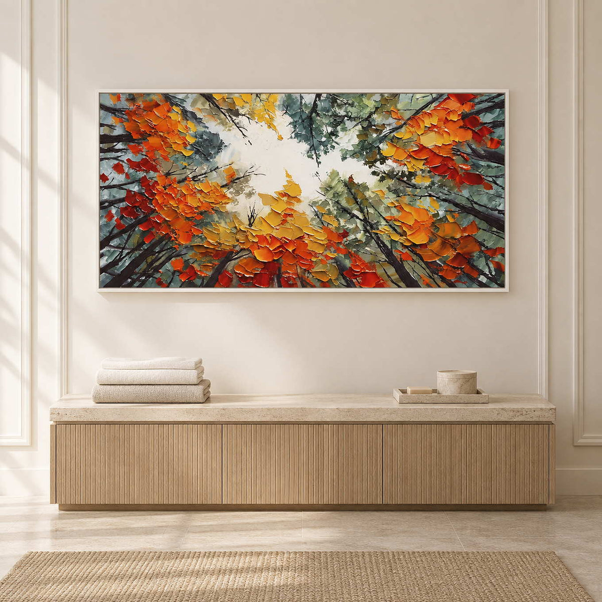 Bright foliage artwork above a low ribbed cabinet in a pale paneled interior.