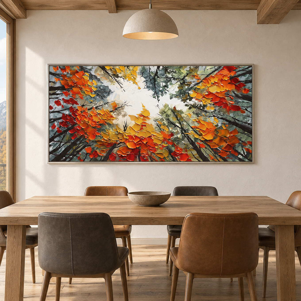 Wide tree canopy painting above a wood dining table under a dome pendant light.