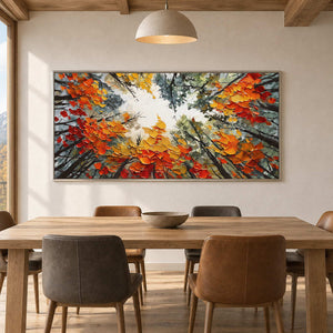 Wide tree canopy painting above a wood dining table under a dome pendant light.