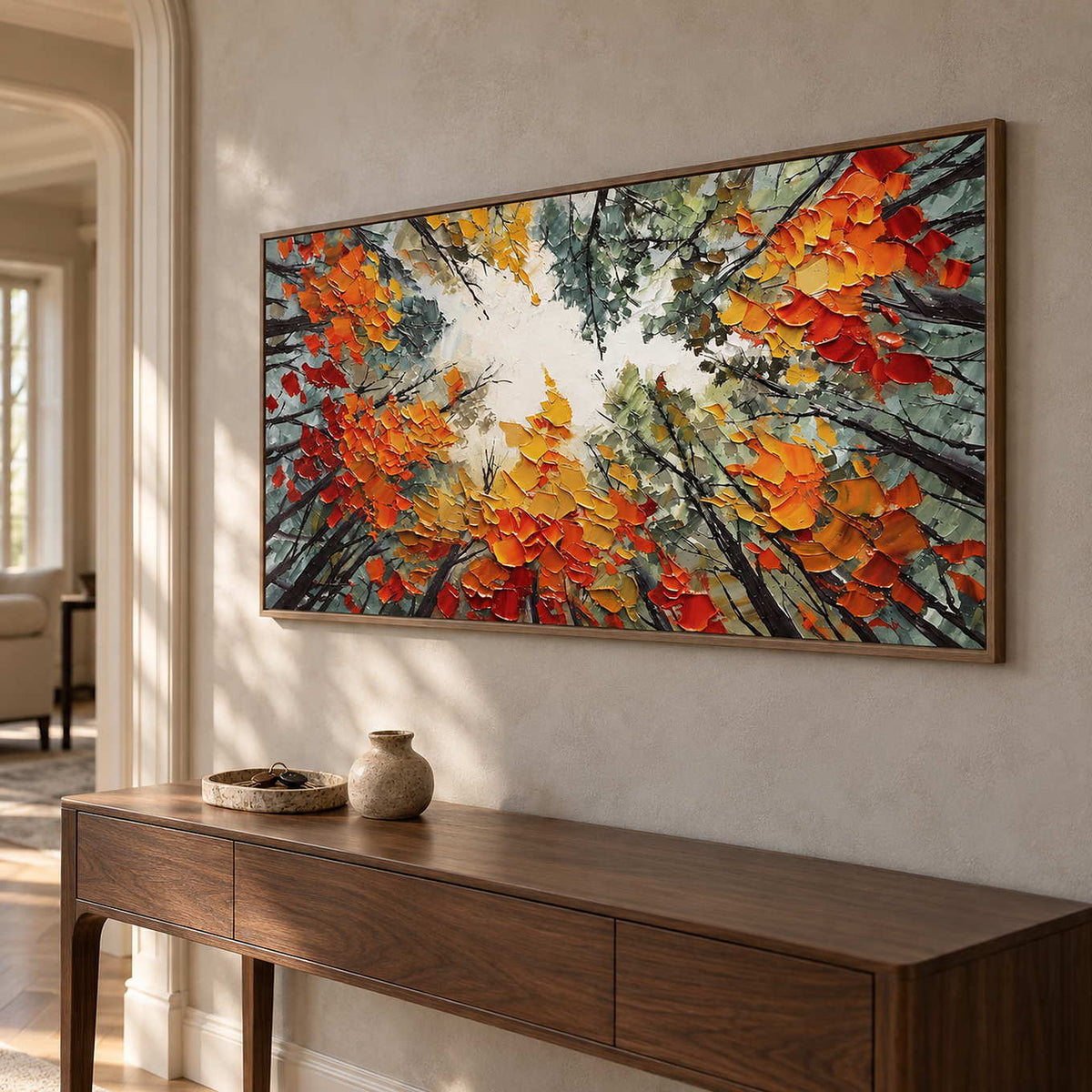 Angled view of the tree painting above a dark wood console near an arched doorway.