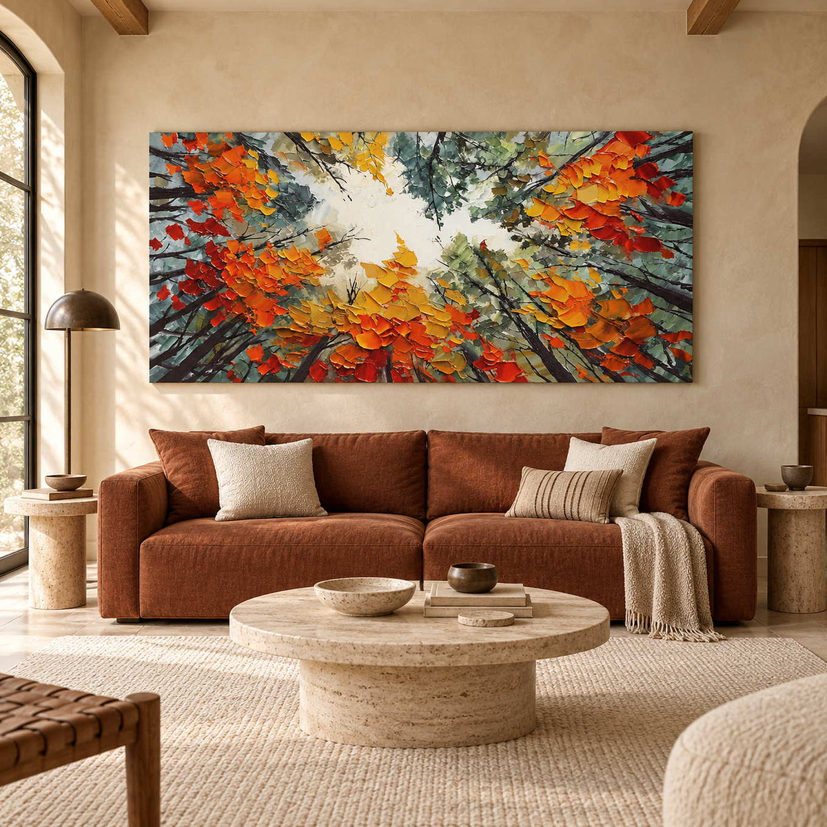 Orange and yellow canopy artwork above a rust-colored sofa and pale round coffee table.