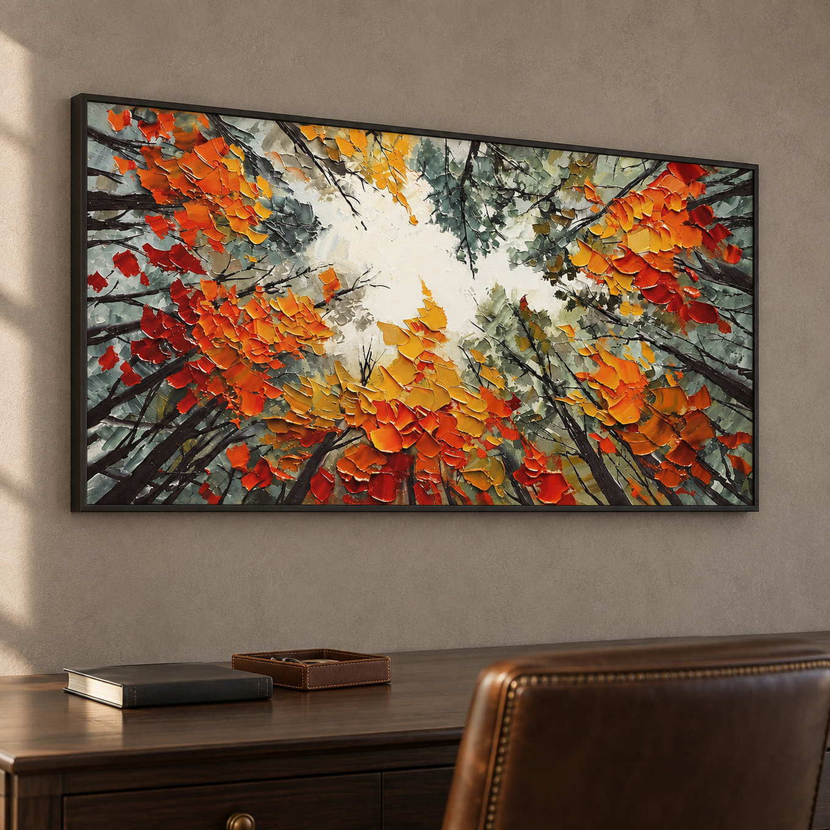 Orange-leaf canopy artwork behind a dark desk and brown chair in a study.