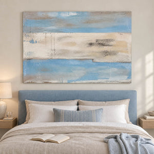 Pale blue and ivory coastal abstract painting with sand and charcoal bands without an outer frame in a bedroom.