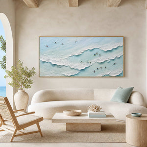 Textured coastal wall art above a curved sofa in an airy living room.