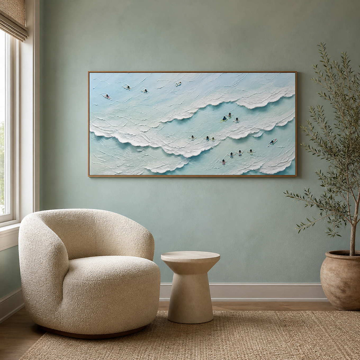 Textured ocean wall art paired with a cream chair in a quiet reading nook.